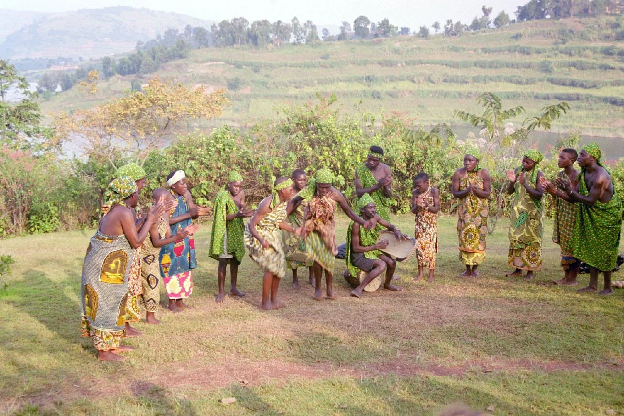 Batwa dancers performing on a grassy slope at Buhoma, Uganda