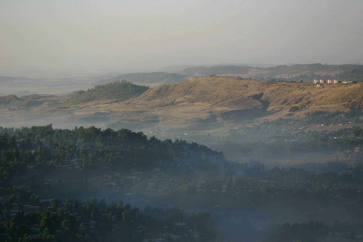 Mist lies over forested ridges and hills in the highlands near Gondar.