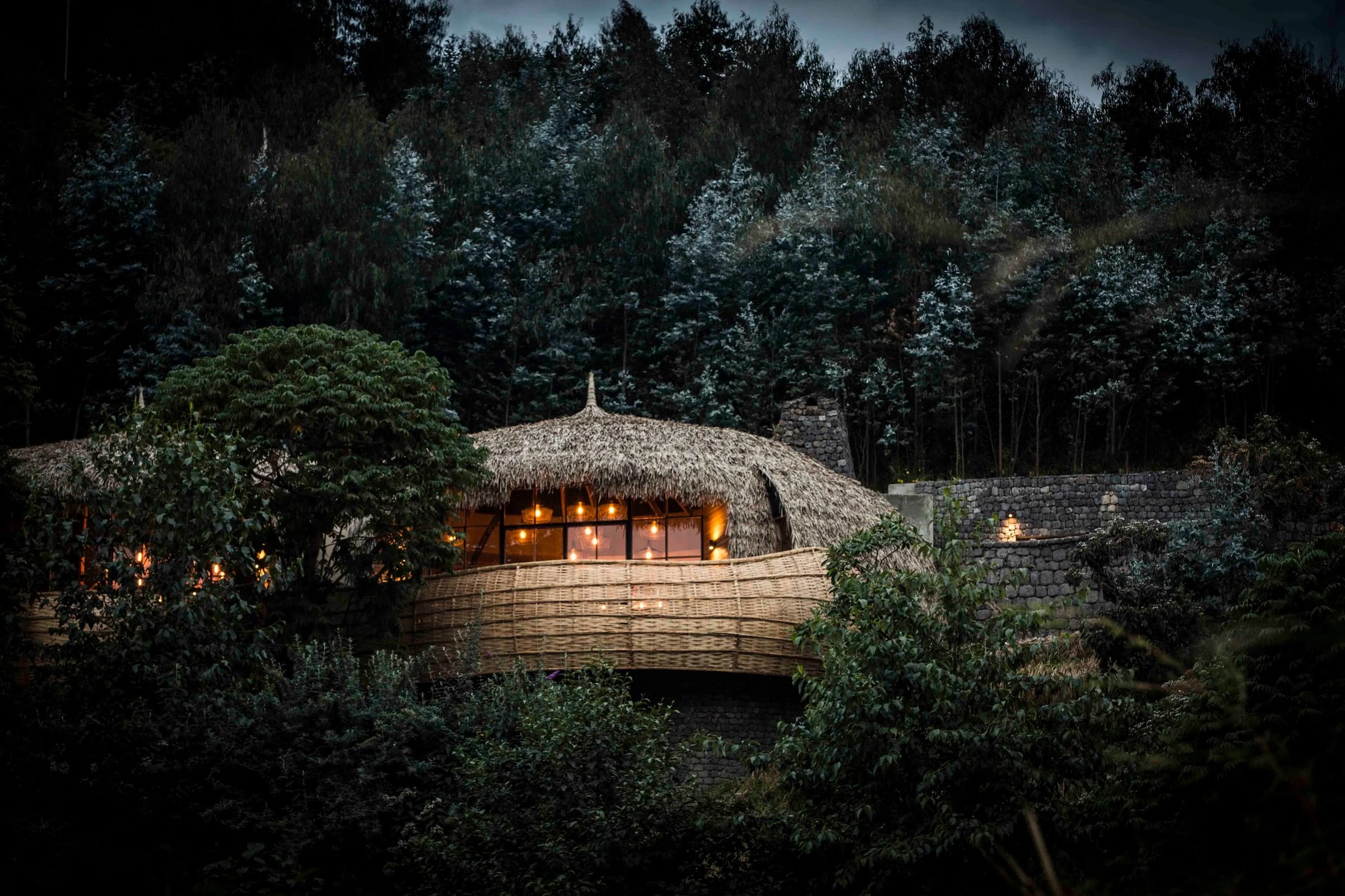 Rounded lodge illuminated amid woodland