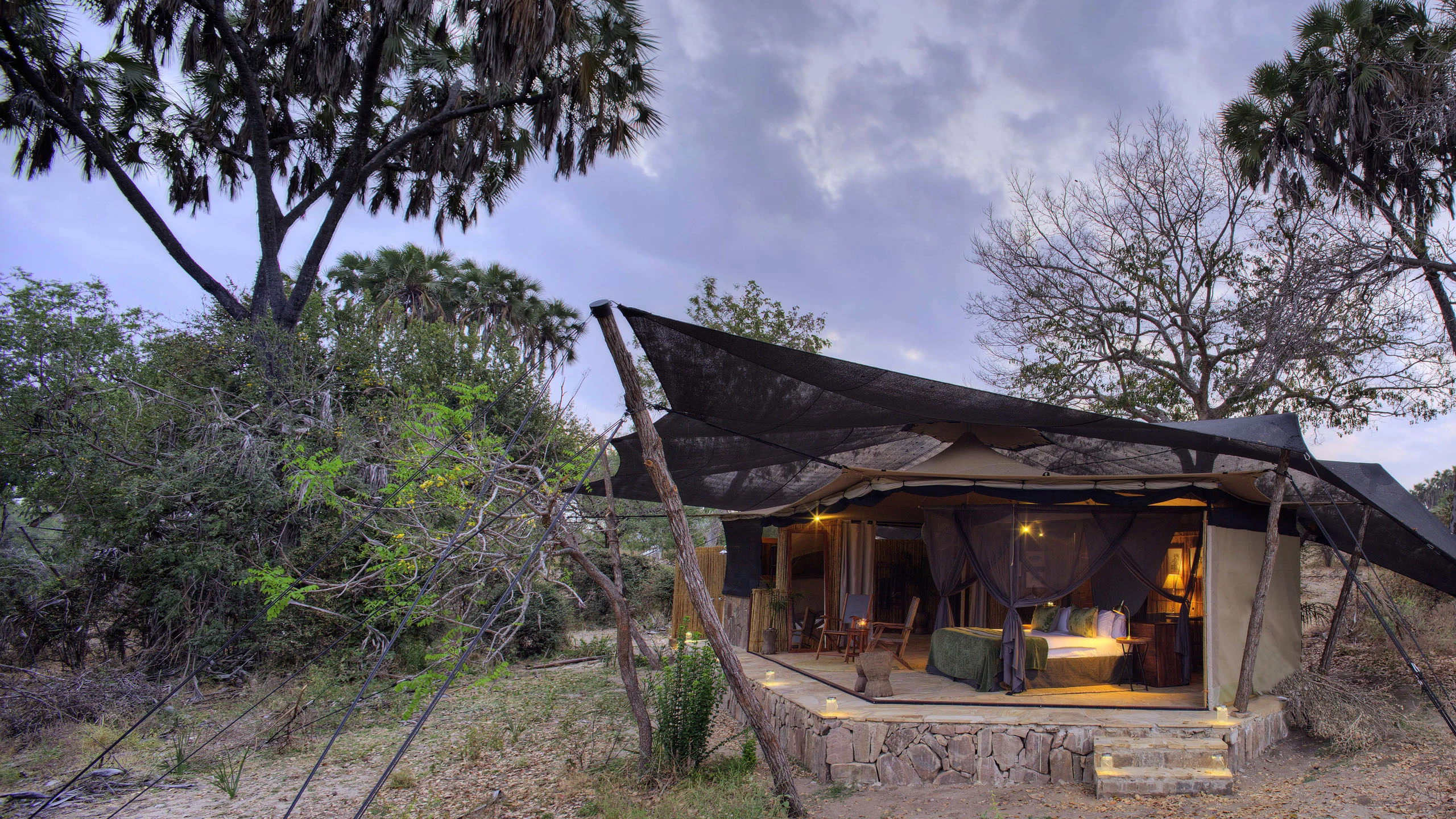 Canvas lodge beneath sloping roof at Roho ya Selous