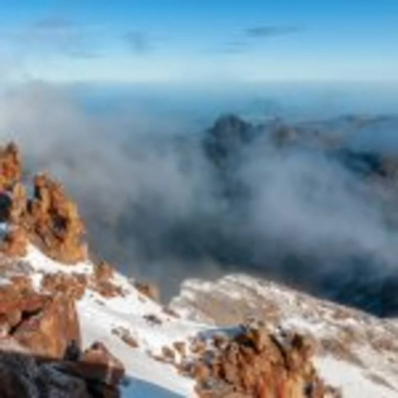 Snow and bare rock on Mount Kenya's high peaks above the cloud