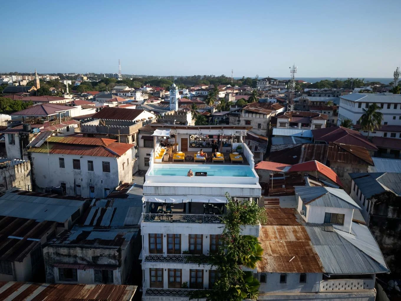Rooftops of Stone Town seen from above, with a rooftop pool