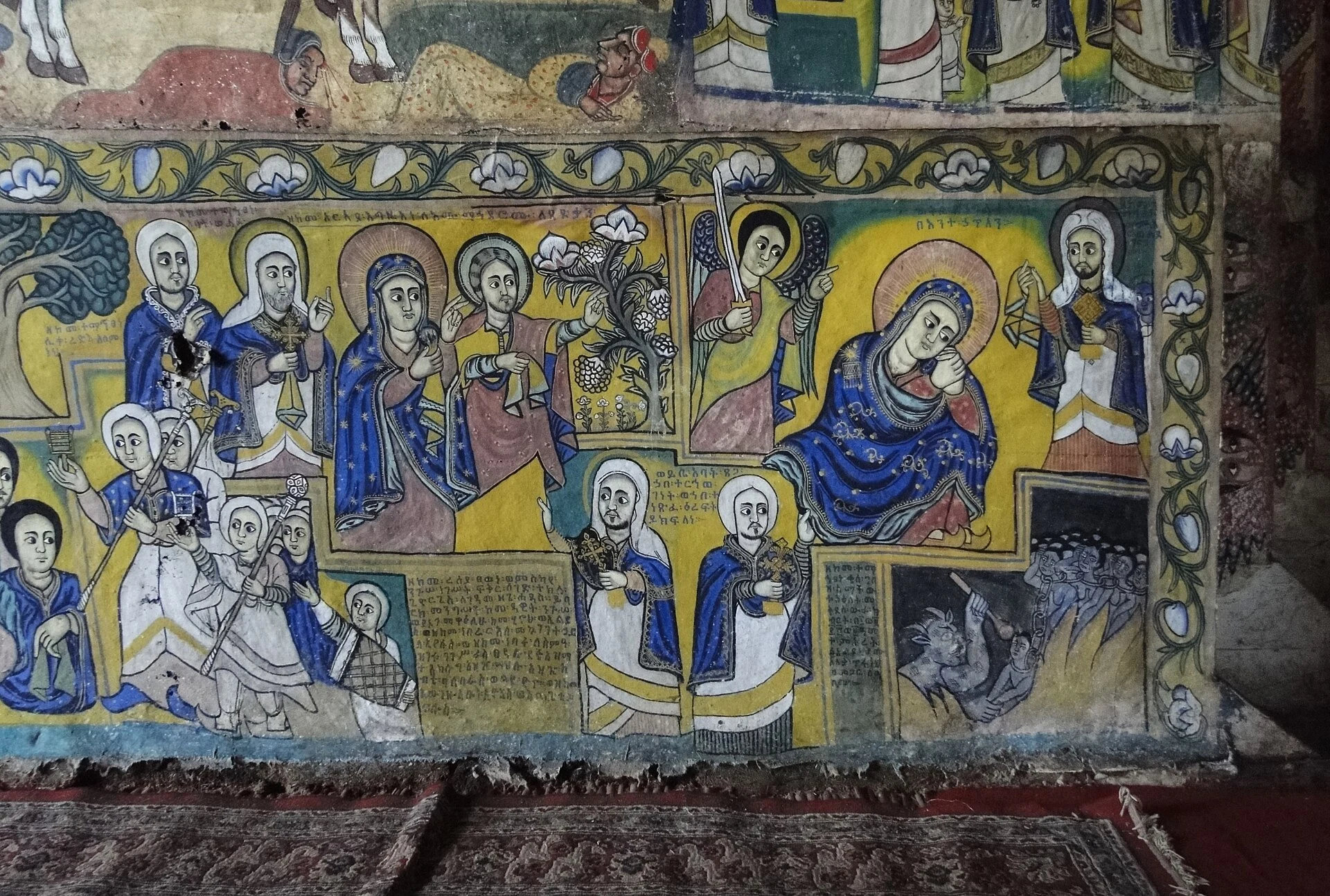 Painted biblical scenes cover a wall inside Ura Kidane Mehret church.