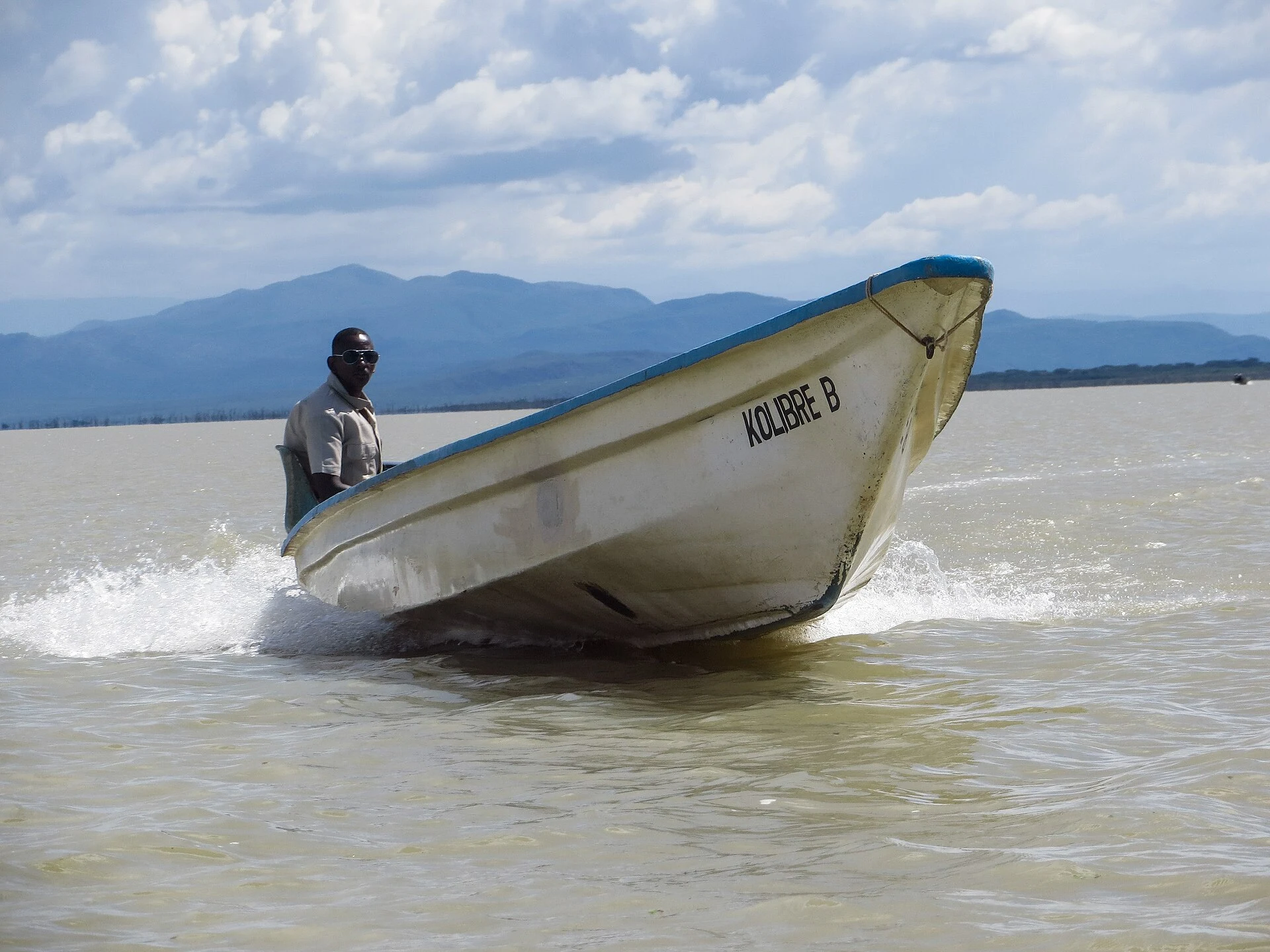 A boatman steering across Lake Baringo