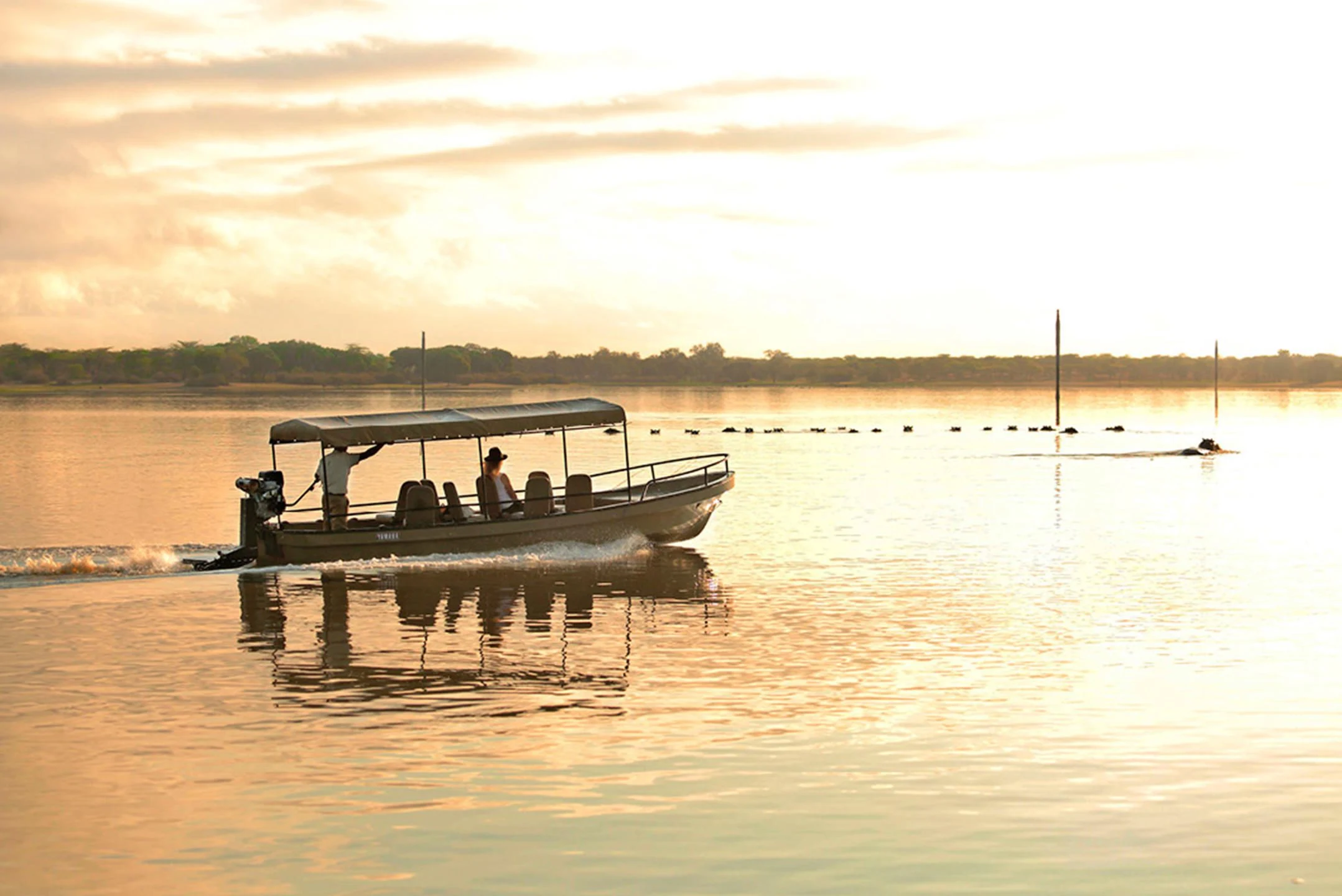 A boat safari on the water at sunset in Nyerere National Park