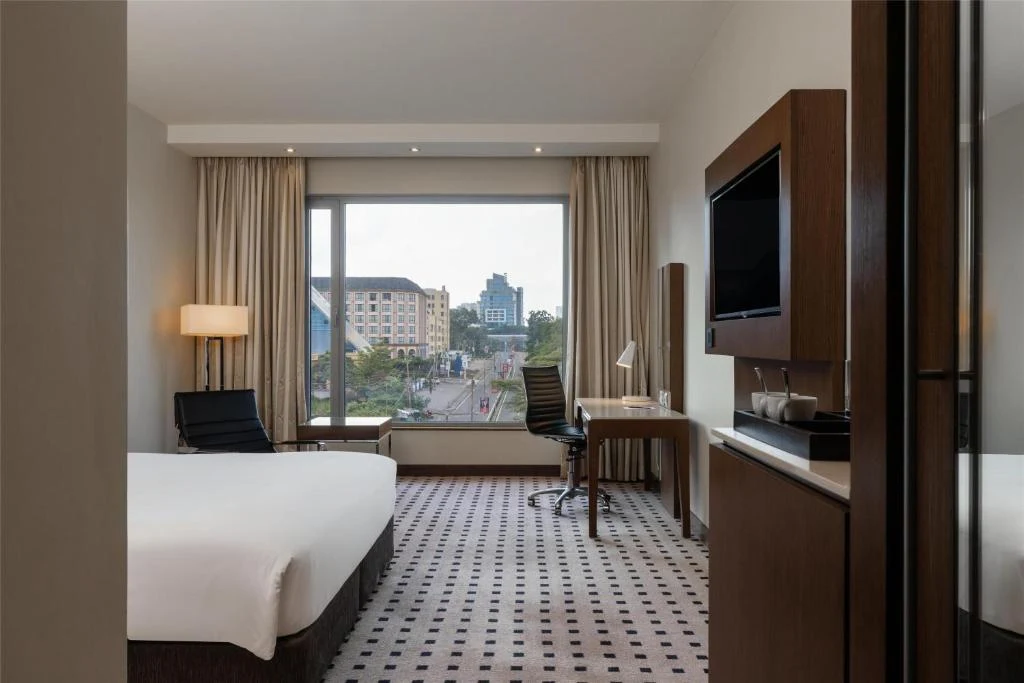 a hotel room with a bed and a large window