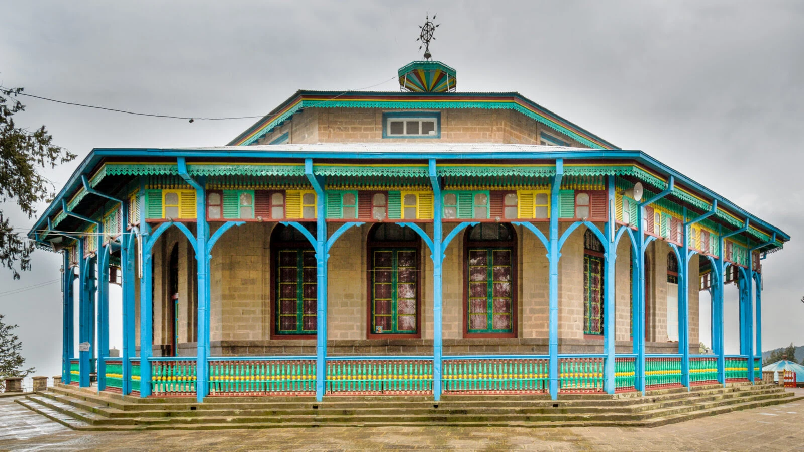 The octagonal Entoto Maryam church with turquoise pillars on the Entoto hills.