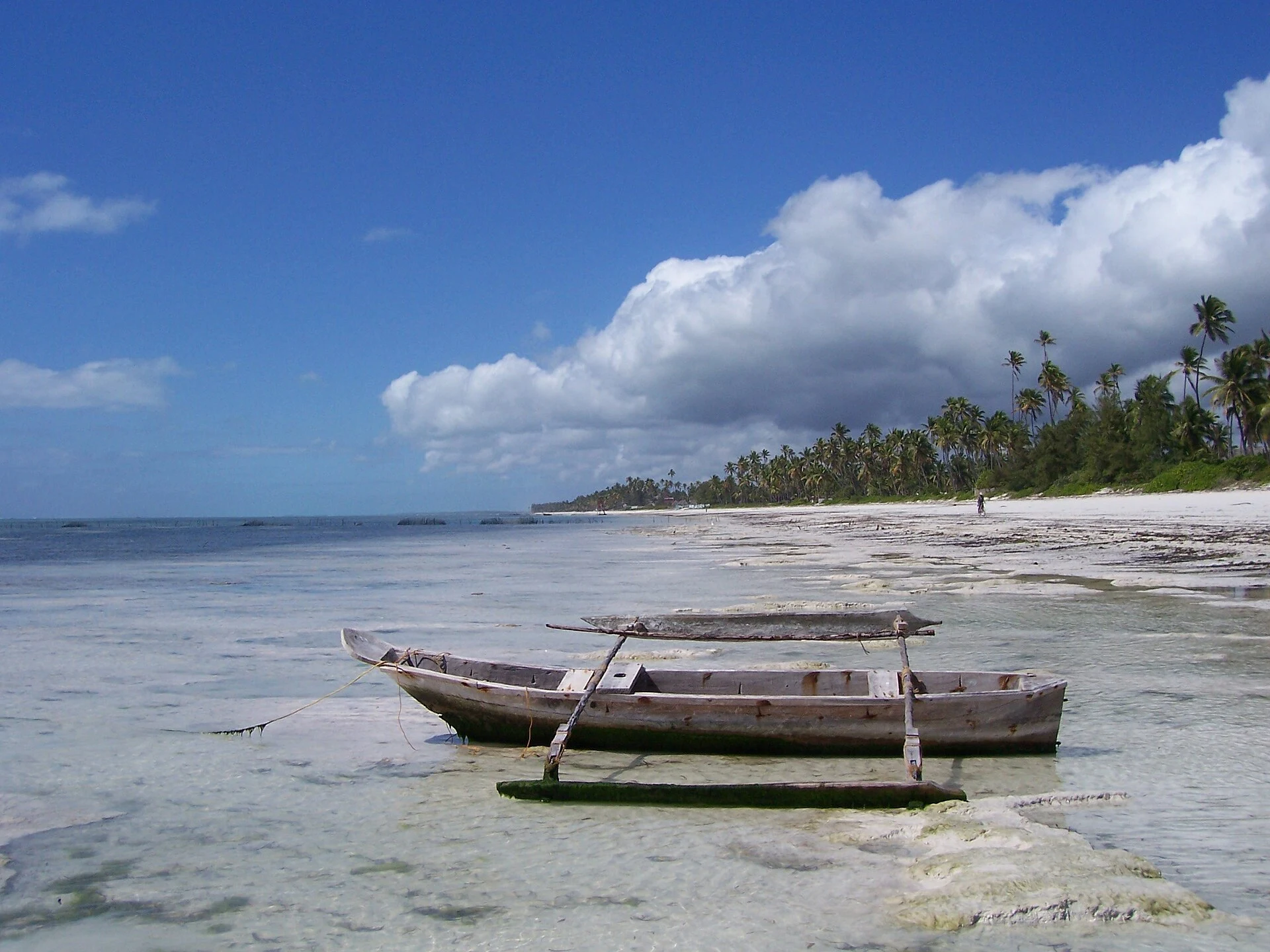 A local outrigger boat resting on the sand at low tide north of Bwejuu