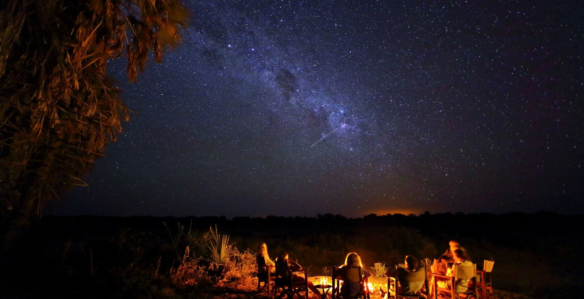 The Milky Way over a campfire in the bush
