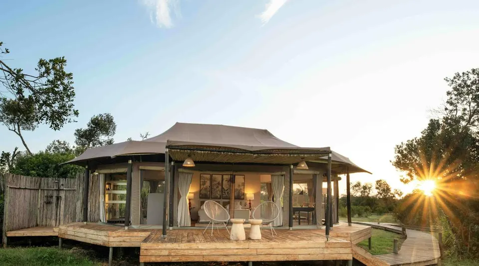 The River Camp tented building and veranda at sunset