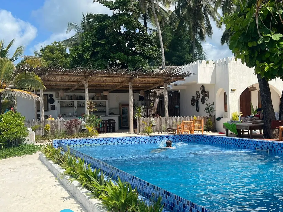 Infinity swimming pool, beach-facing terrace and restaurant at Coco Beach