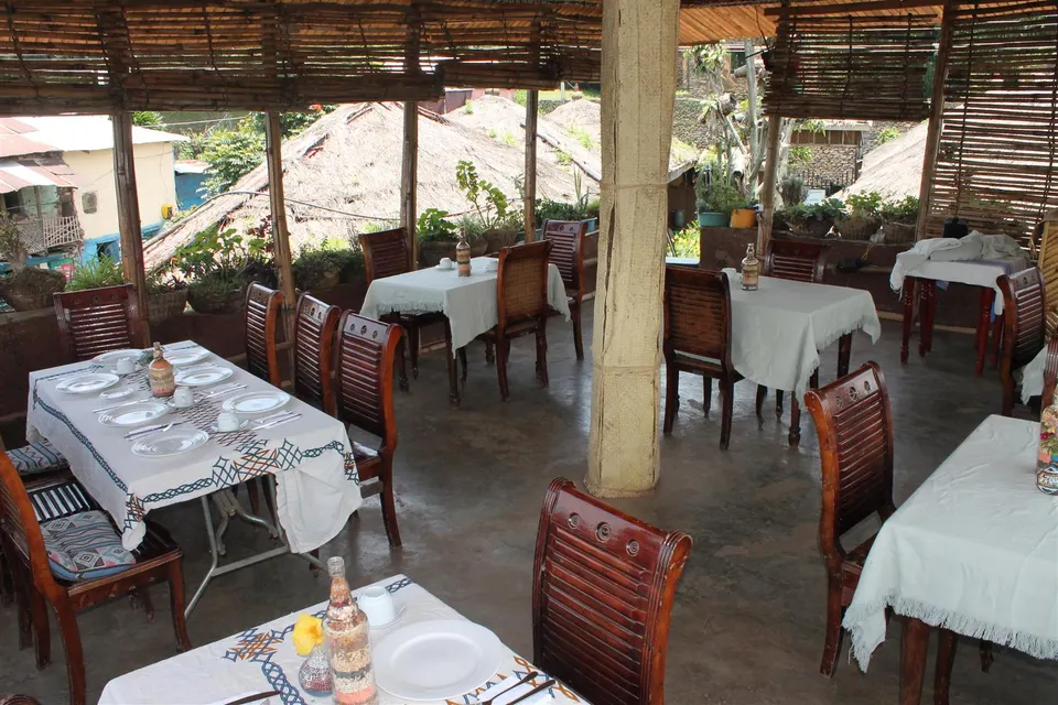 Open-sided dining terrace with set tables