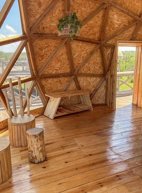 Savana dome interior with timber/glass structure and seating