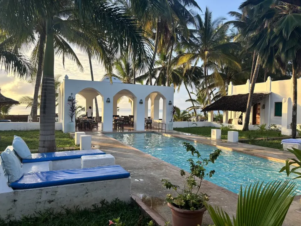 Sawa Sawa Beach House shared swimming pool and white guest buildings