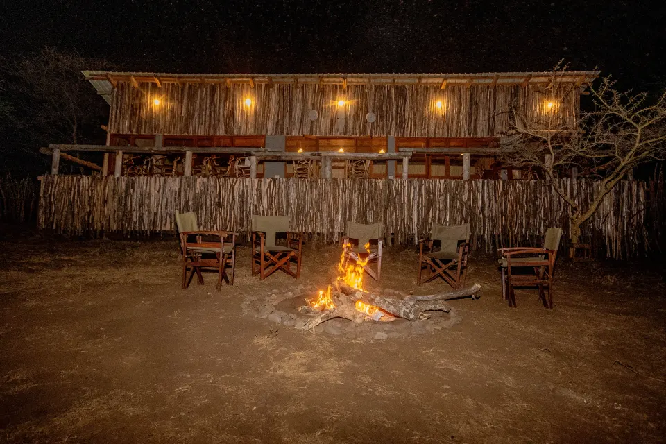 Campfire outside Amani Eserian’s lodge building at night