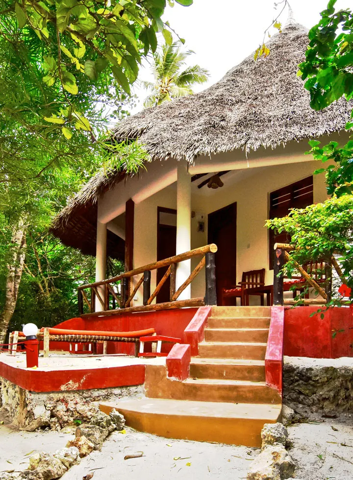Bungalow exterior and shaded veranda at Mangrove Lodge