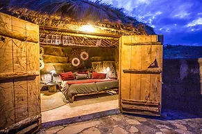 Original Maasai Lodge bungalow interior seen through open doors