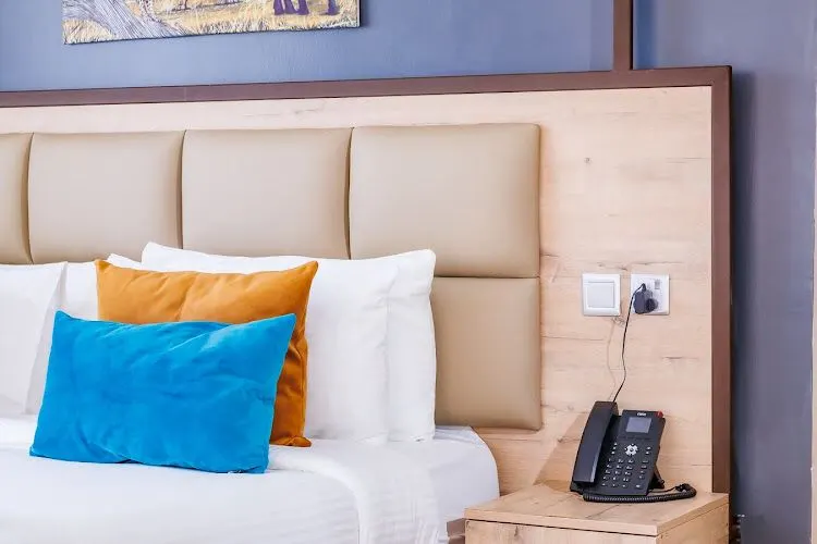 The Warwick Hotel Deluxe room bed and bedside furniture