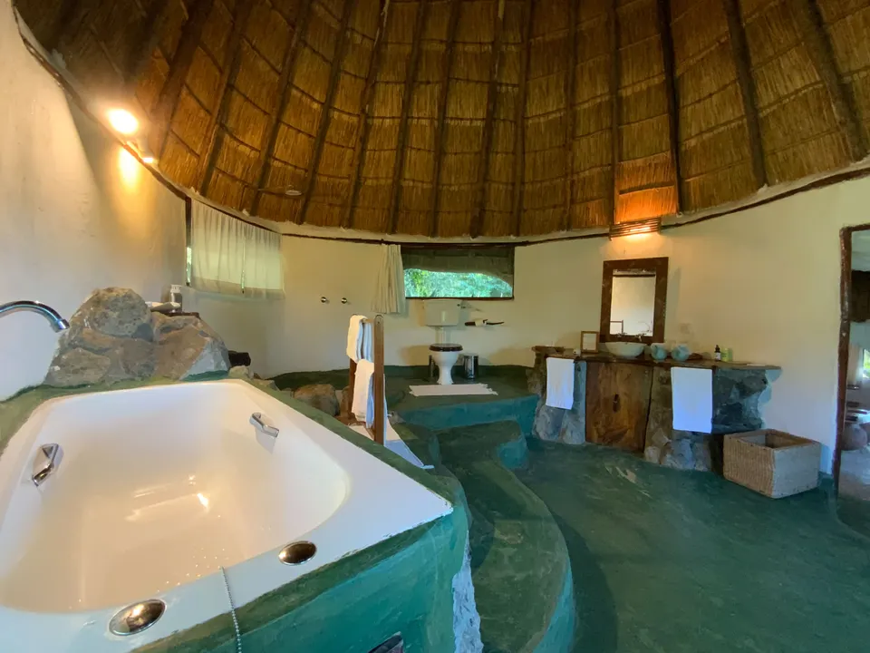 Mfangano Island Lodge Room 7 bathroom with bathtub and thatched roof