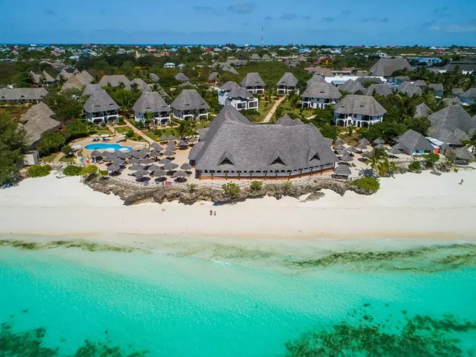 Resort buildings, pool and beach from above