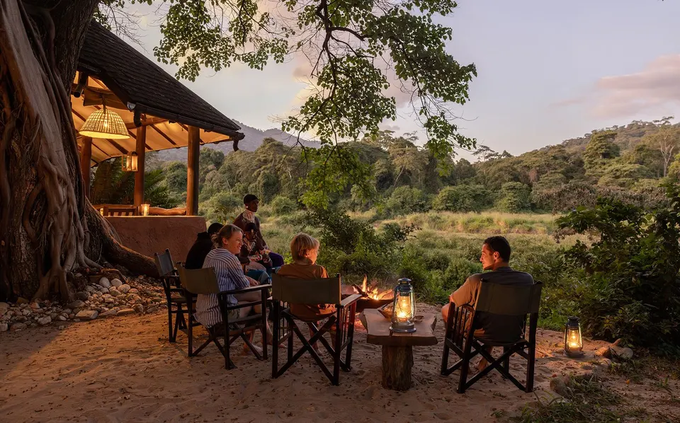 Kitich guests around an outdoor fire beside camp