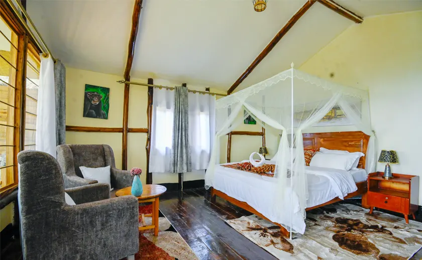 Gorilla Mist Camp bedroom with netted bed and upholstered sitting area