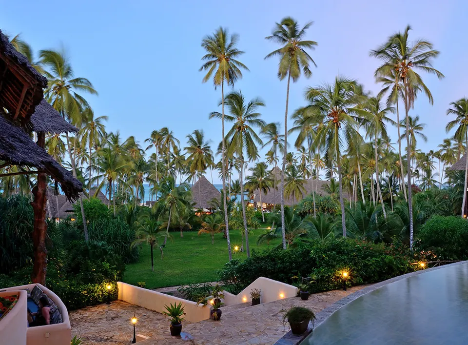 Ocean Paradise gardens and resort buildings at dusk