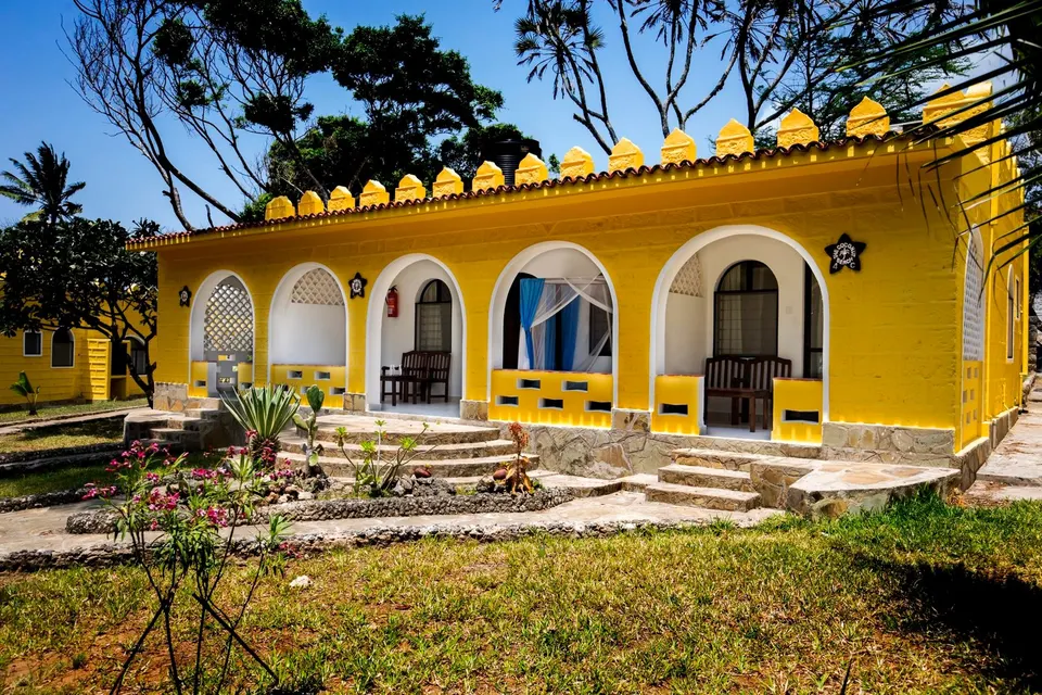 Coconut Beach Lodge yellow cottage exterior