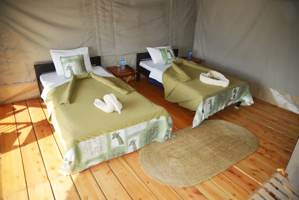 Ngorongoro Kuhama guest tent with twin beds and timber floor