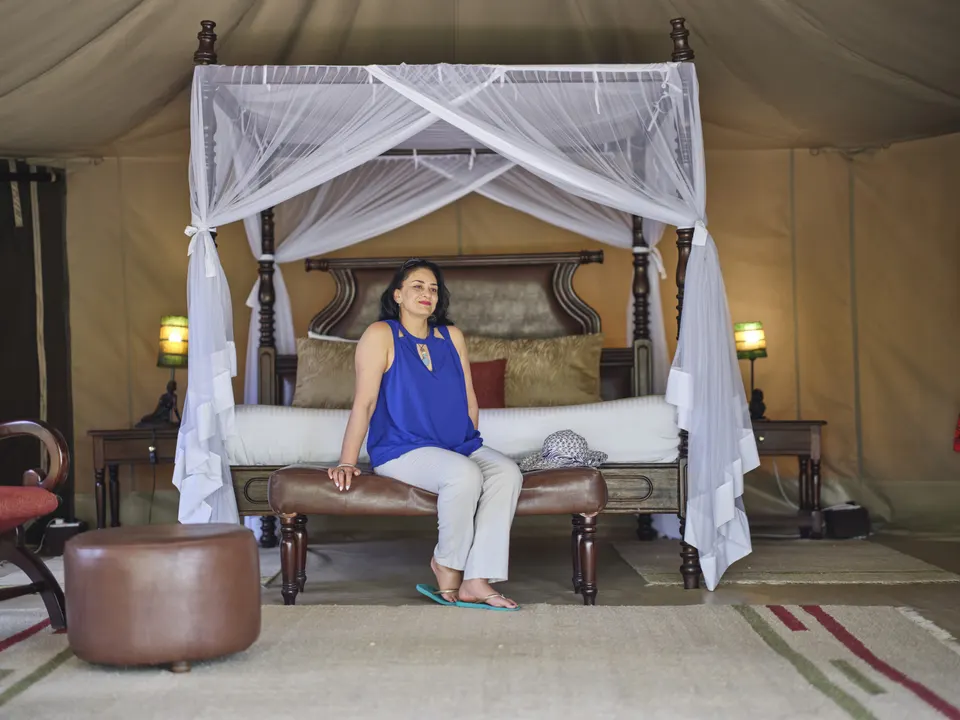Mara Ngenche bedroom with seated guest
