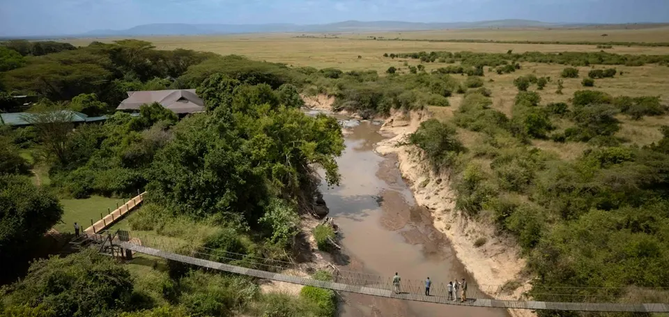 Camp and footbridge beside Talek River