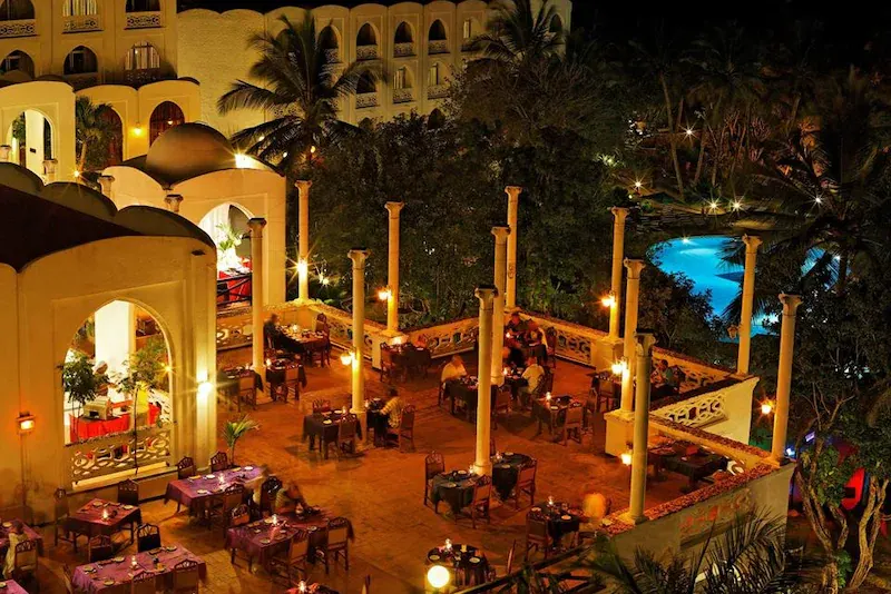 Hotel exterior and dining terrace at night
