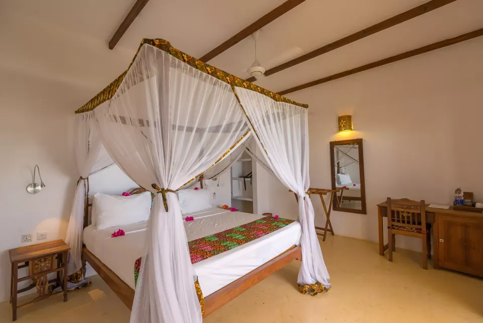 Guest room with a wooden canopy bed