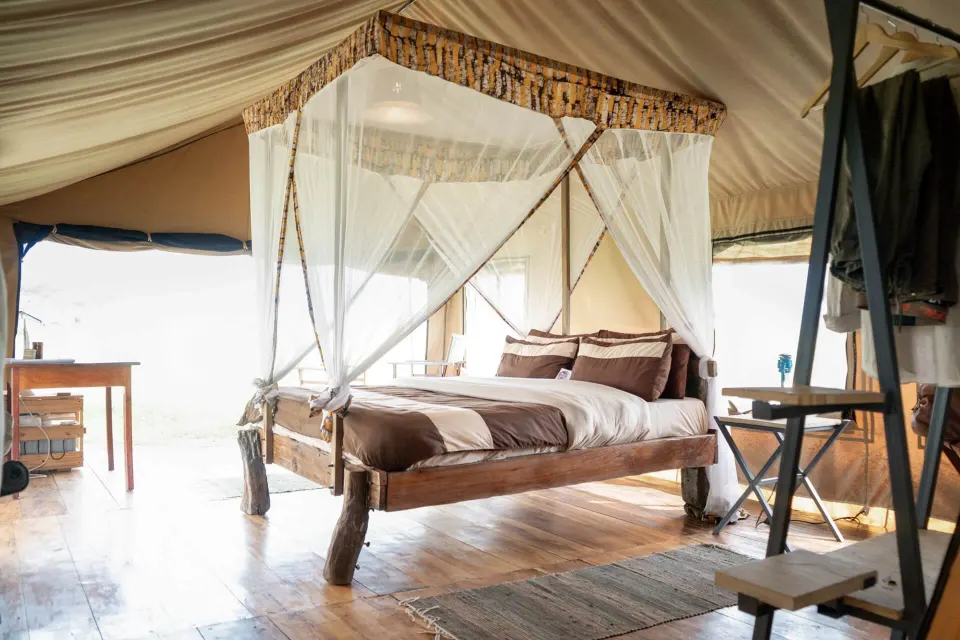 King bed in a guest tent at the Serengeti camp