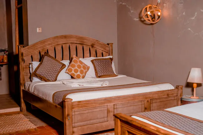 Cottage bedroom with wooden bed and mosquito net
