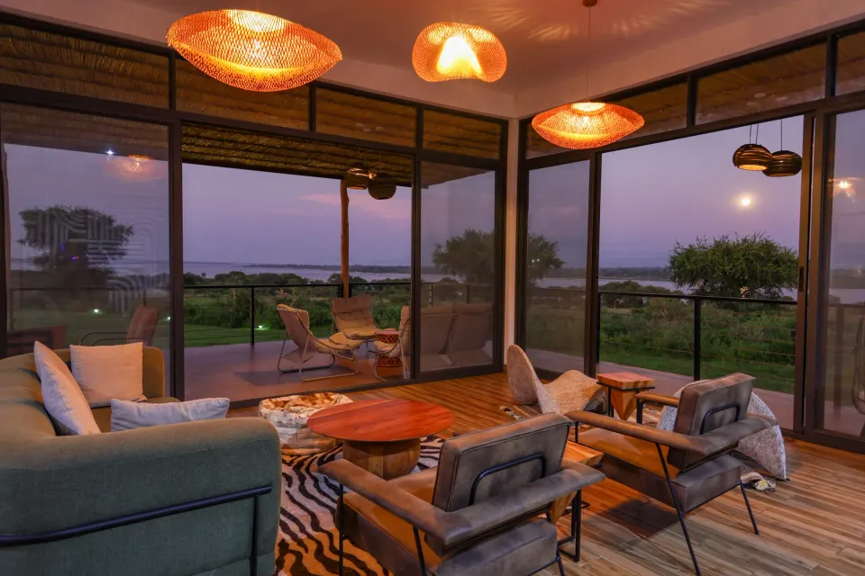 Pakuba Safari Lodge lounge and landscape outlook at dusk