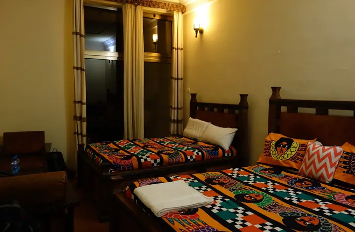 Top Twelve Hotel bedroom with two visible beds