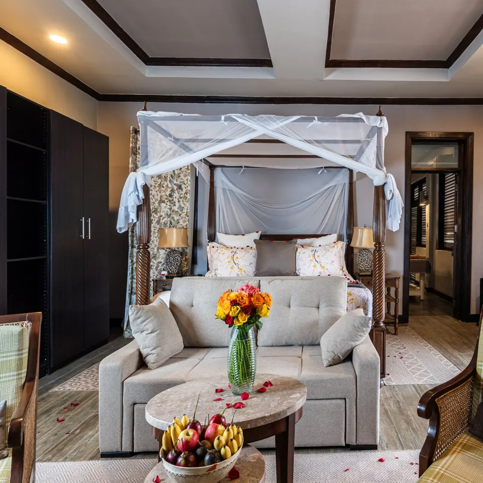 Master Suite with canopy bed and lounge at the Volcano Manor, Five Volcanoes Boutique Hotel Rwanda
