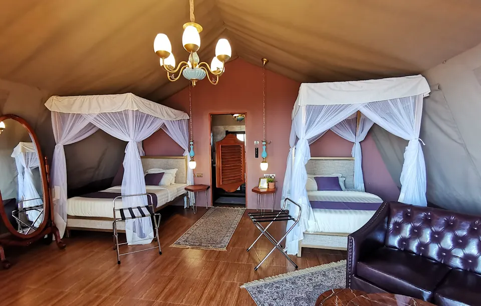 Twin-bed tent interior with mosquito nets and seating