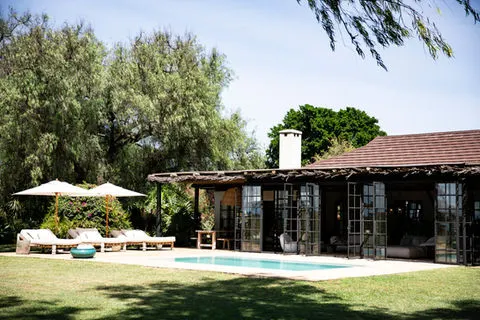 Segera low-rise house, lawn and pool; exact category unassigned