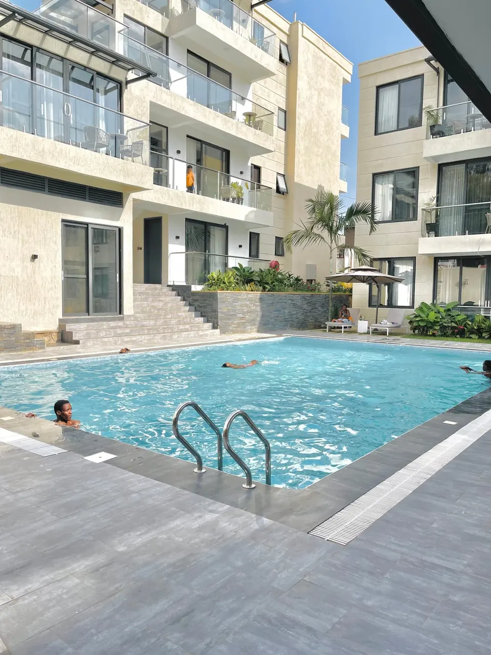 Step Apart Hotel outdoor pool and apartment balconies