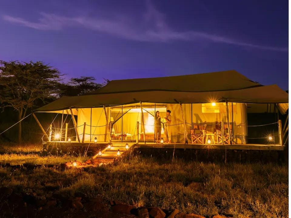 Kifaru guest tent exterior at dusk