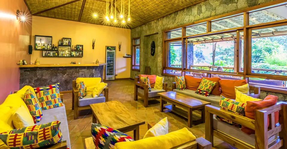 Ichumbi Gorilla Lodge main-house lounge seating and bar
