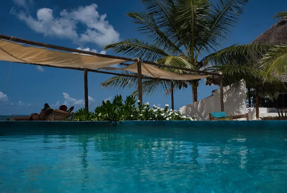 AVO pool with shaded beach loungers