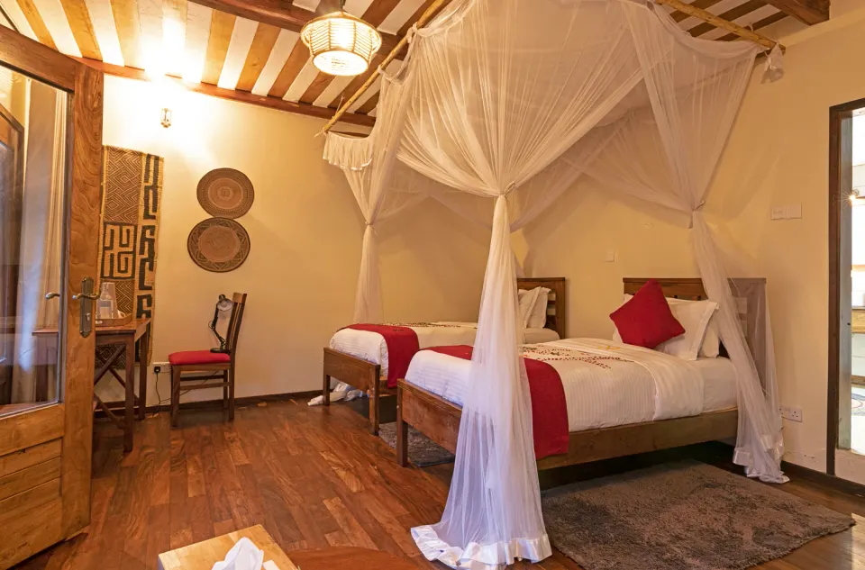 Four Gorillas Lodge twin bedroom with mosquito net
