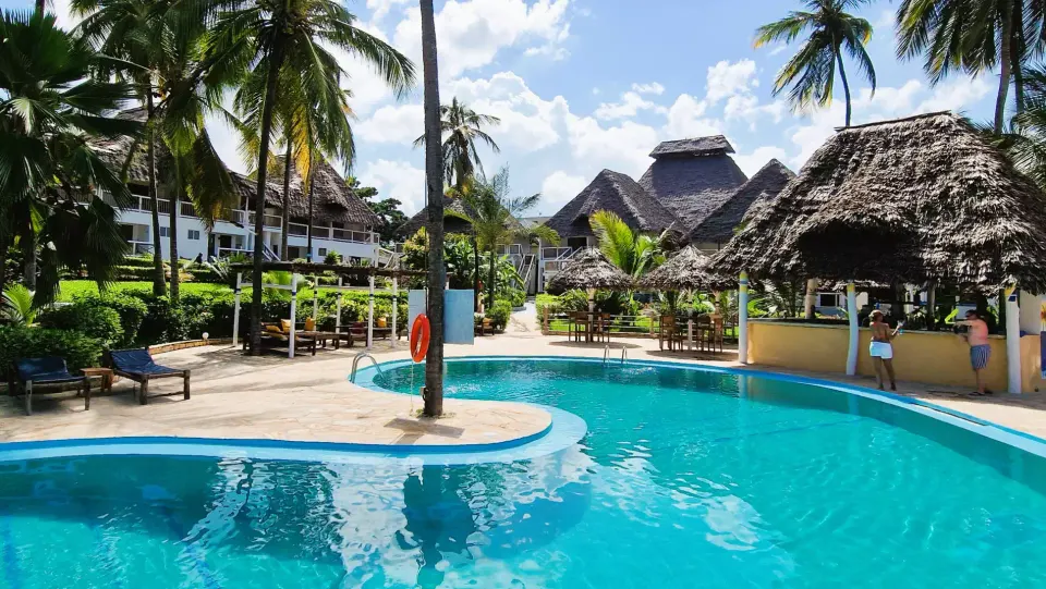 Paradise Beach Resort pool and thatched buildings