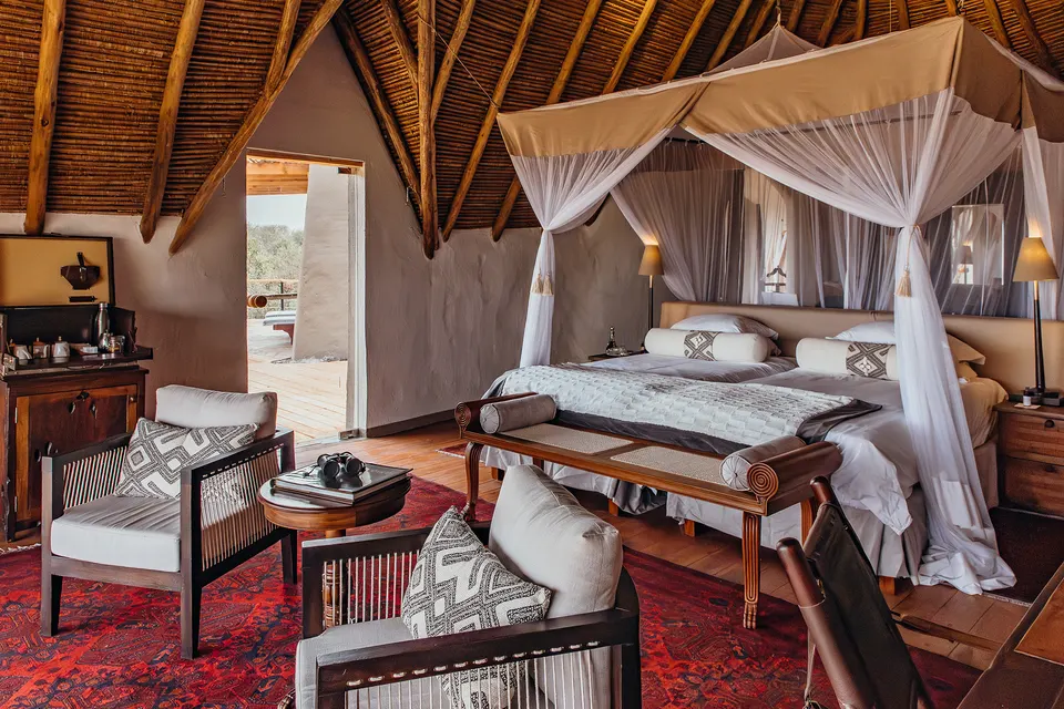ol Donyo Lodge suite interior with bed and seating