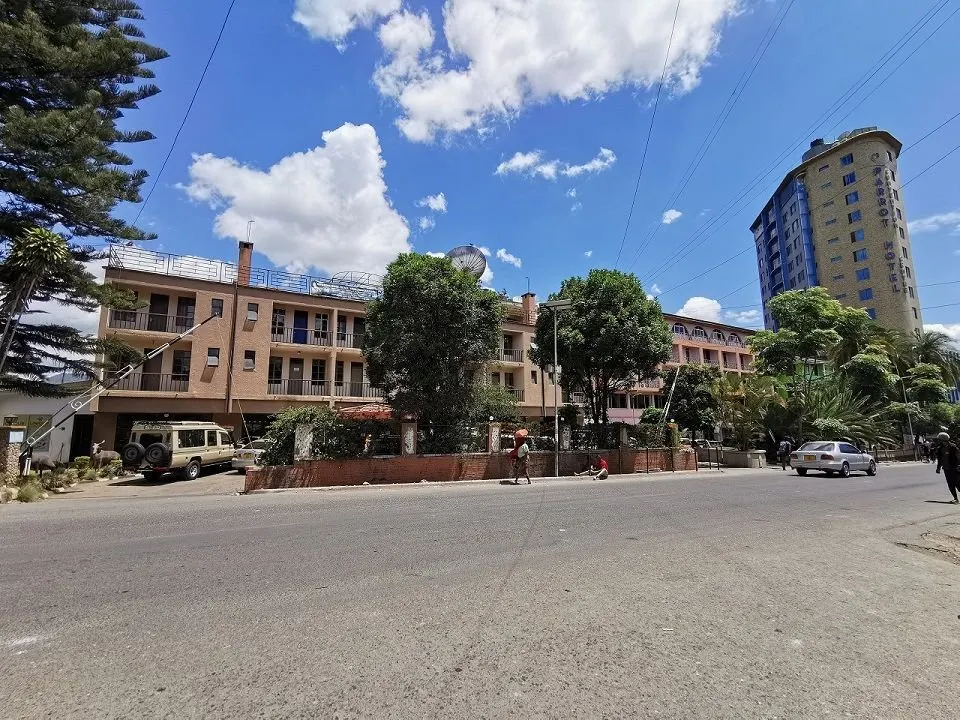 Golden Rose low-rise building and street; tall neighbouring tower is a different hotel