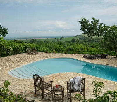 Kyambura Gorge Lodge swimming pool and savanna outlook; public inline preview