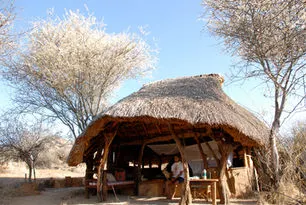 Open stone-and-thatch camp building